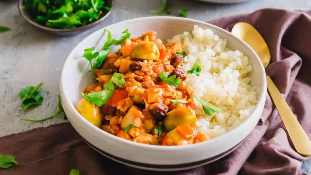 Vegan tempeh picadillo served in a bowl with cauliflower rice.