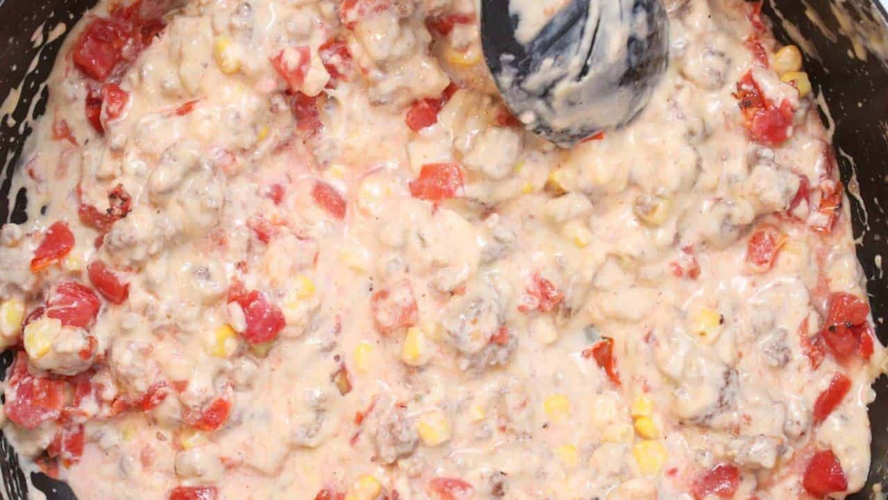 A close up of cheesy leftover taco meat pasta dish.