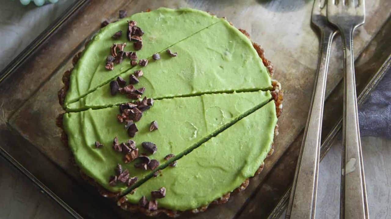 Avocado lime tart with granola crust topped with cacao nibs.