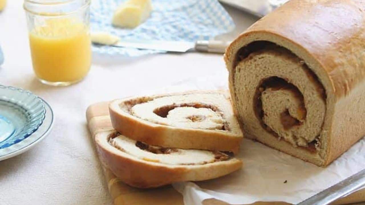 Loaf of roasted peach cinnamon swirl bread with two slices cut off.