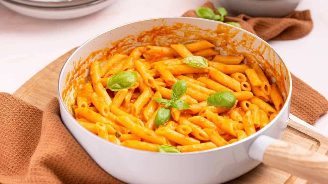 An close up photo of cooked penne pomodoro in a pot.