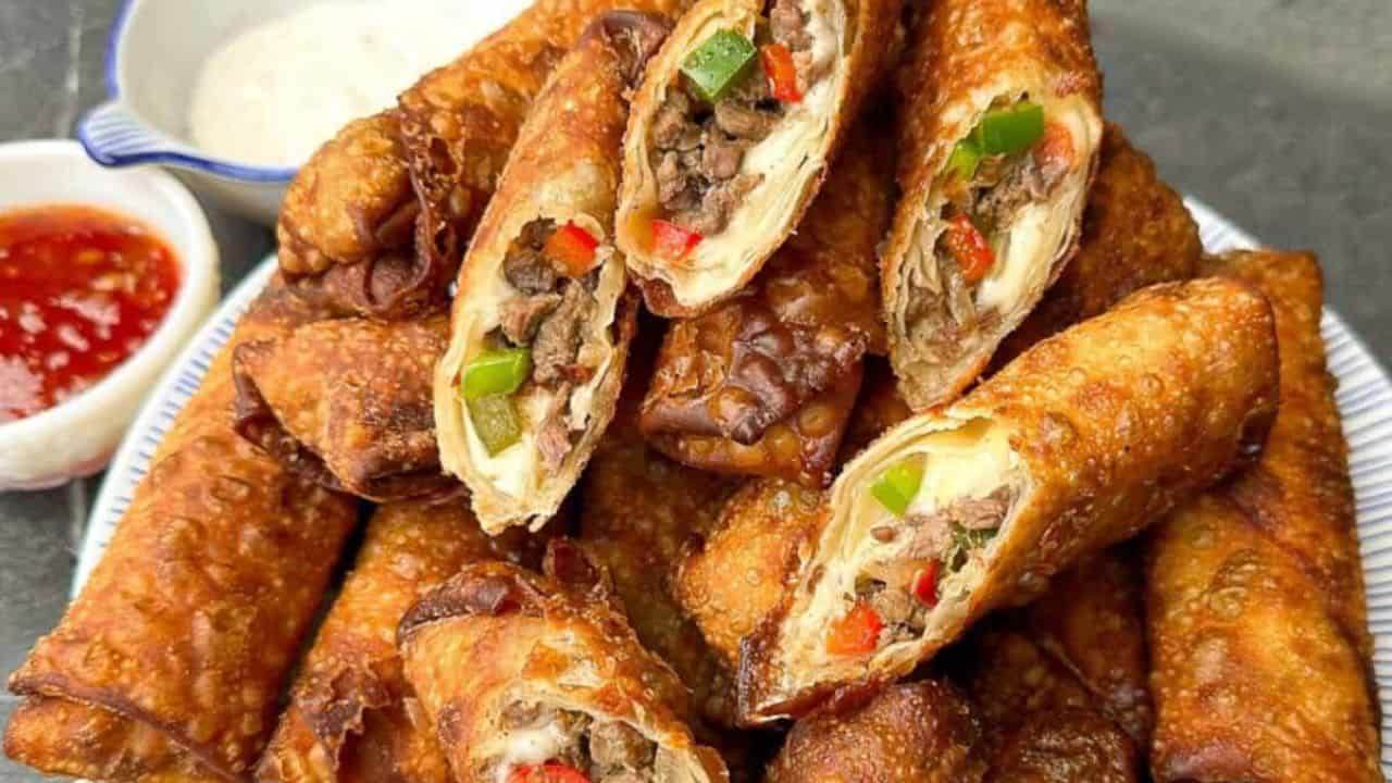Crispy egg rolls stuffed with cheesy Philly cheesesteak filling.