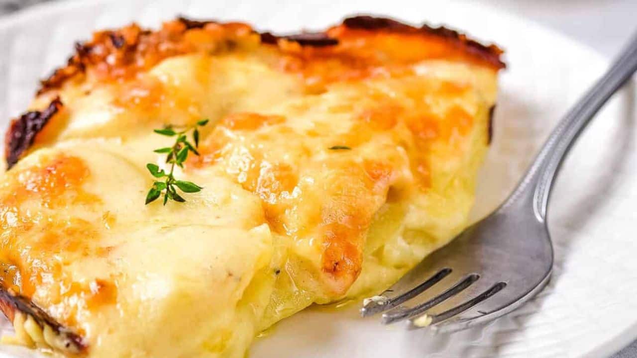 Overhead shot of potatoes au gratin cooked in an oval baking dish.