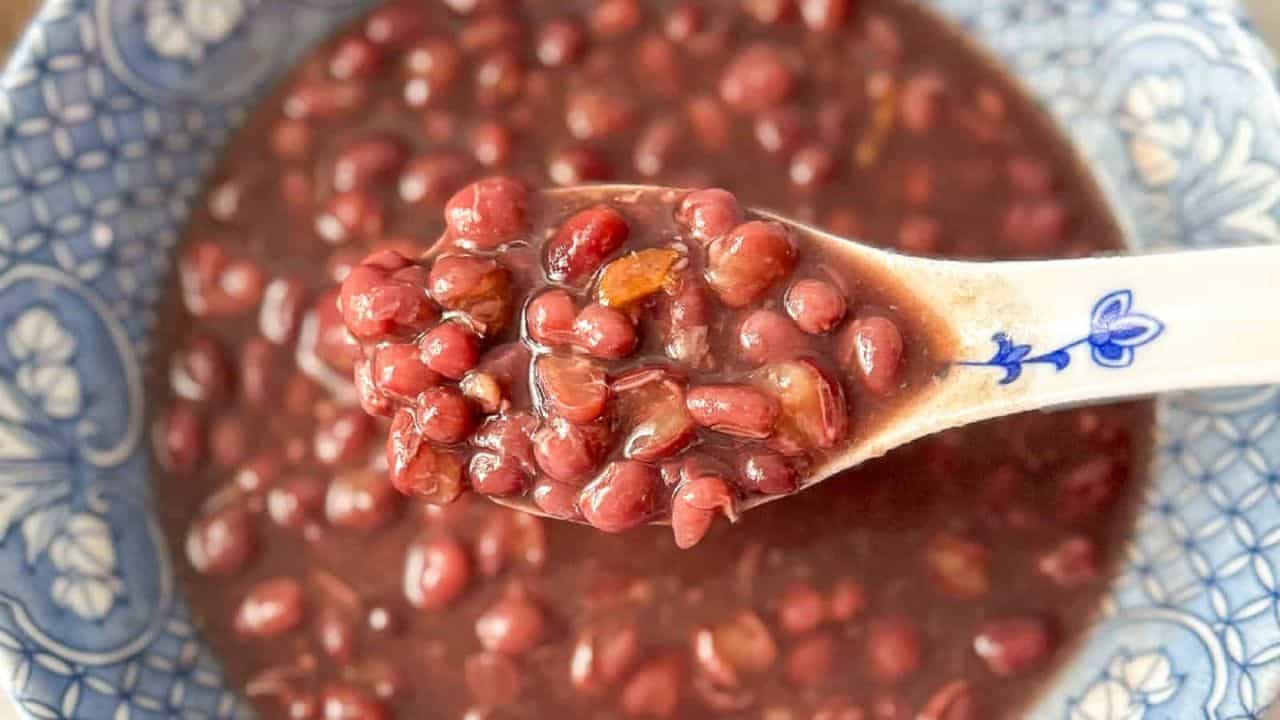 Close-up of warm red bean soup in a blue and white color bowl.