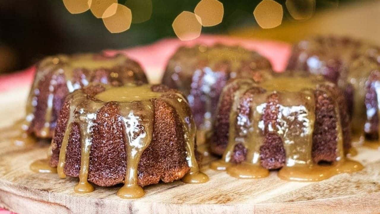 A plate of sticky toffee pudding cakes with caramel sauce.