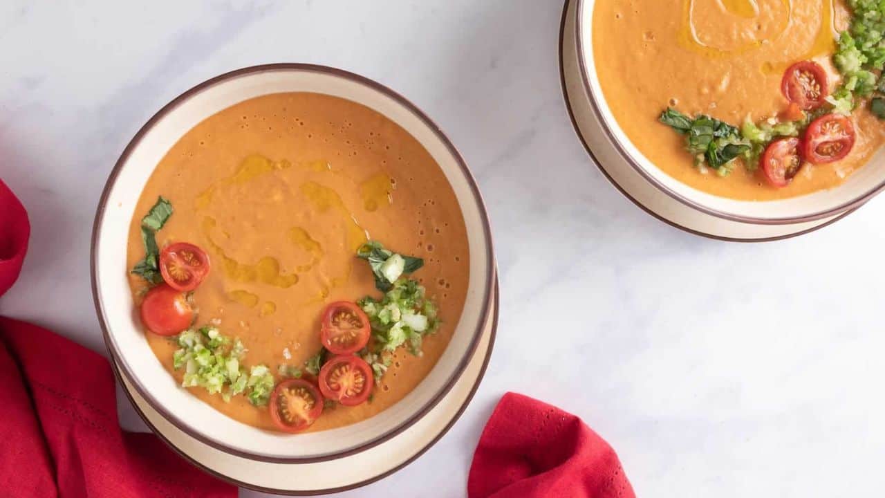 An overhead image of two gazpacho dish in a white bowl.