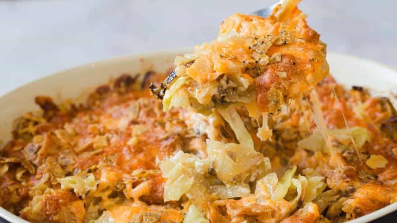 A casserole dish filled with a cheesy cabbage casserole.