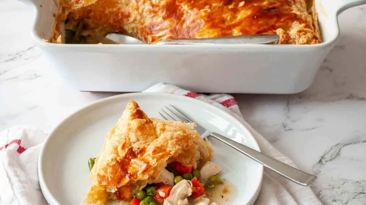 A plate with pot pie on it and a fork.