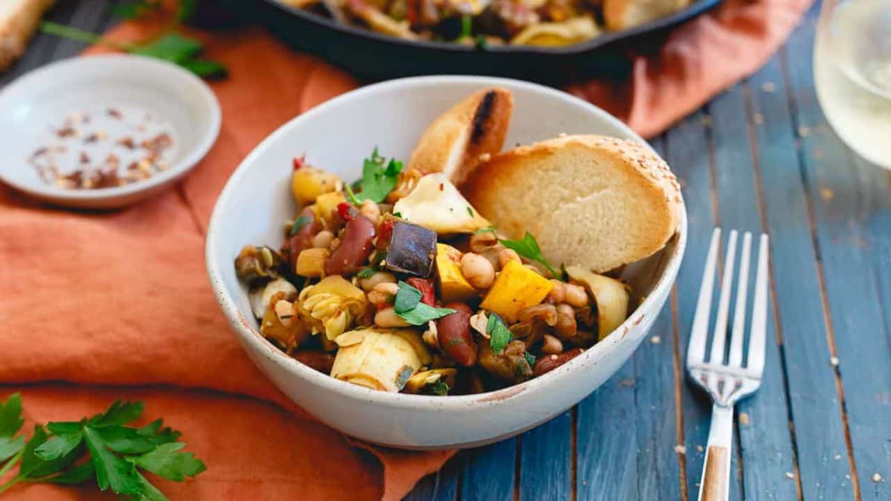 Cast iron skillet with beans and vegetables.
