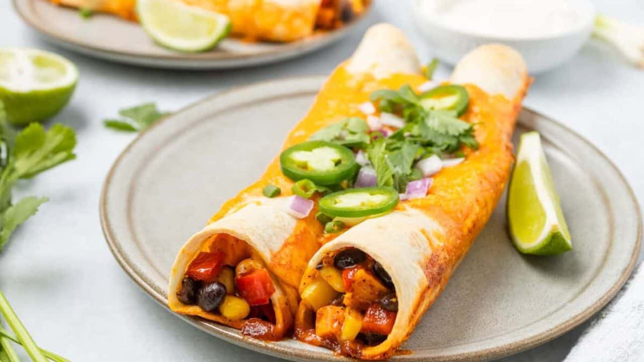 A close up image of a serving of vegetarian enchiladas on a plate.