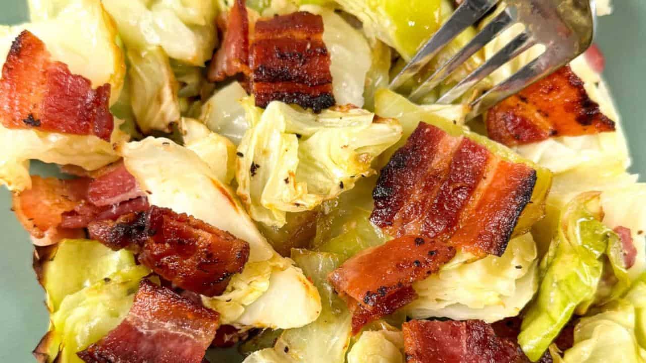 Baked cabbage with bacon on a green plate.