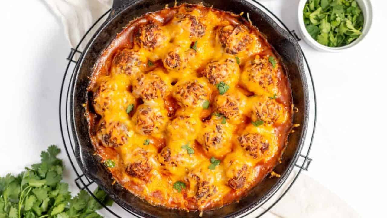 Cheesy mexican meatballs in a skillet.