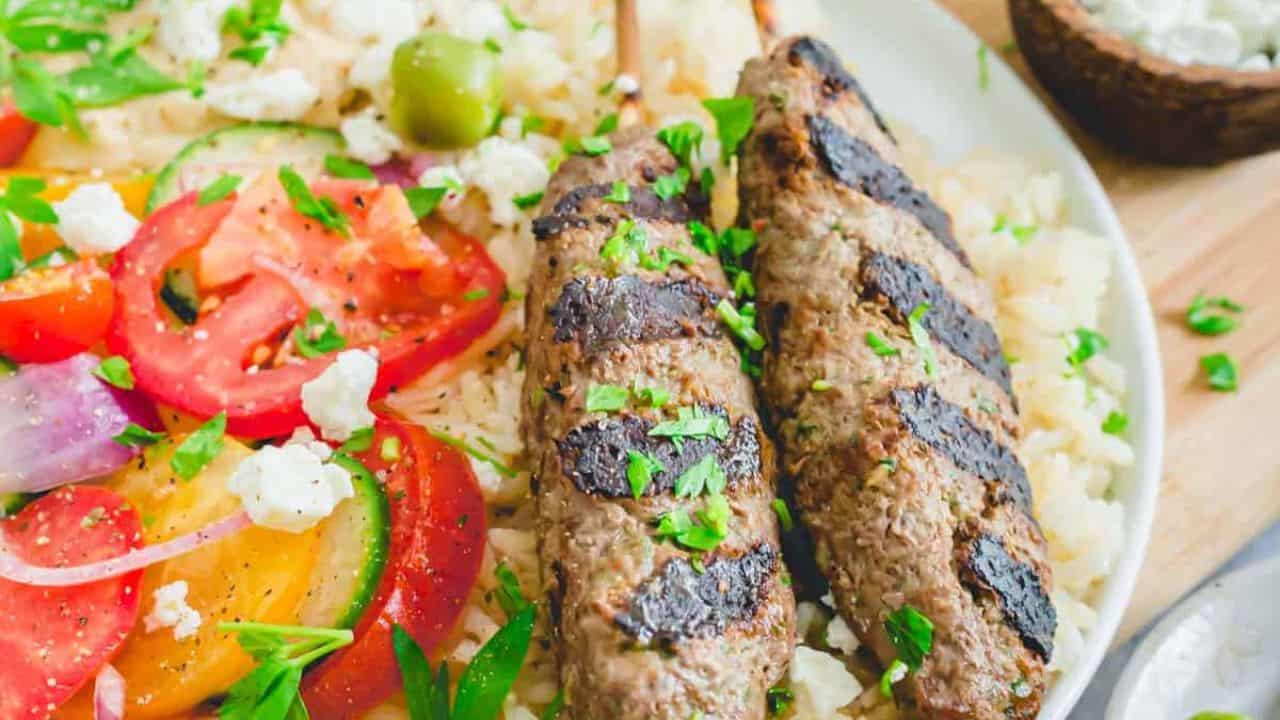 Beef Kafta on a plate with veggies.