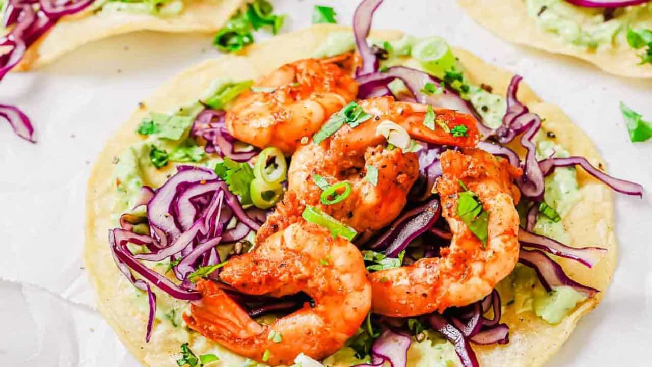 Spicy shrimp tostadas on a cutting board.