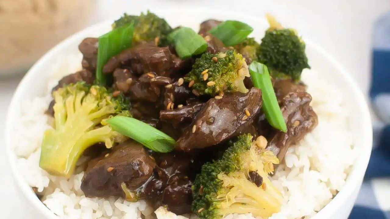 Teriyaki beef served on top of a bed of white rice.