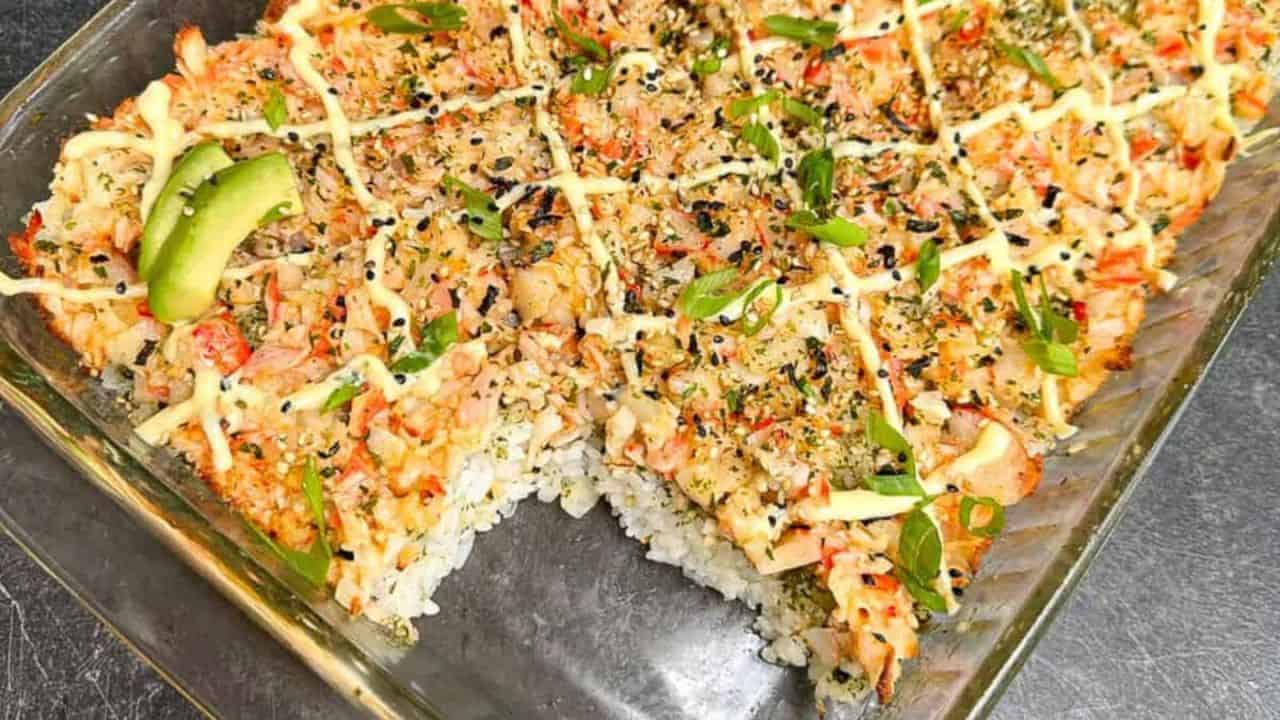 Easy and delicious sushi bake casserole with creamy imitation crab in a baking dish.