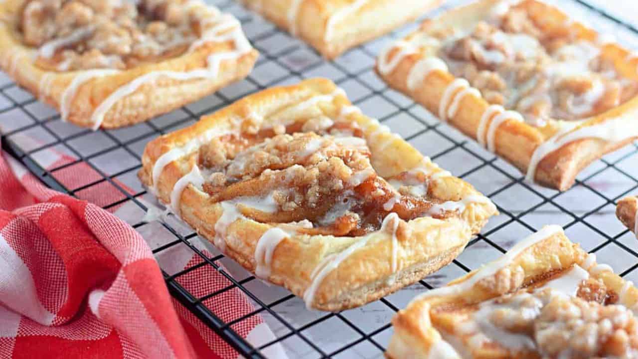 Icing on top of a apple crumble danish.