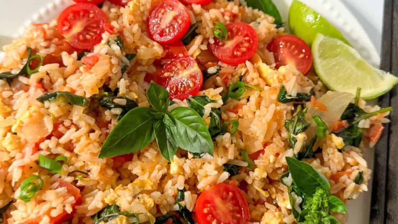 Basil fried rice with toamto and fresh basil on the top.
