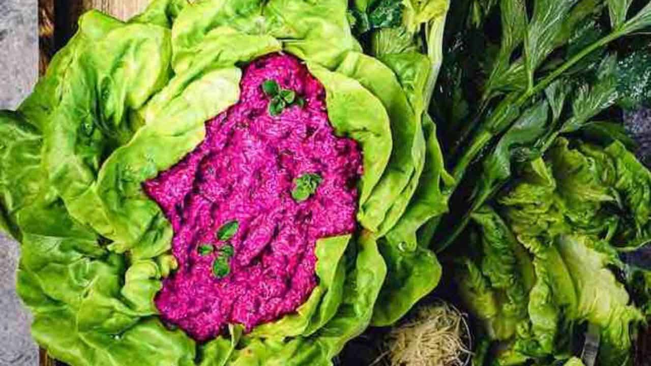 Bright purple beet spread inside a ceramic bowl.