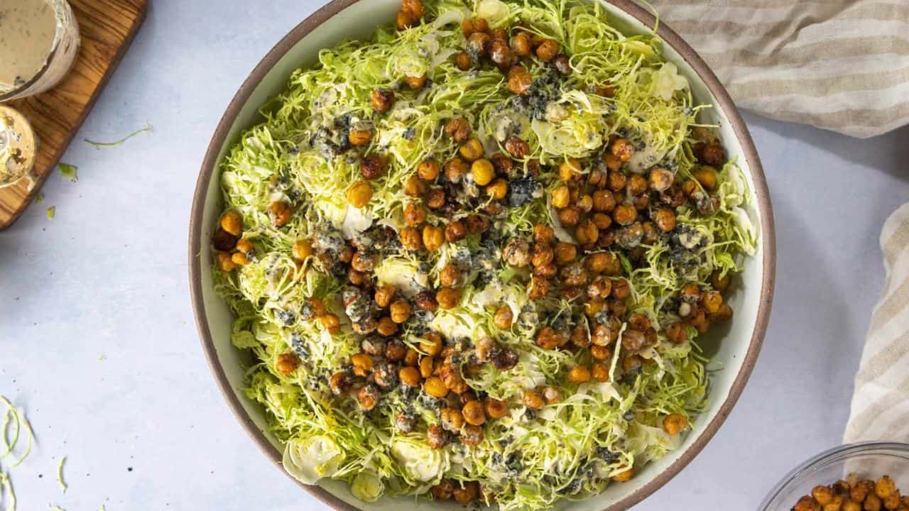 An overhead image of Vegan Caesar Salad with Shaved Brussels Sprouts in wooden bowl.