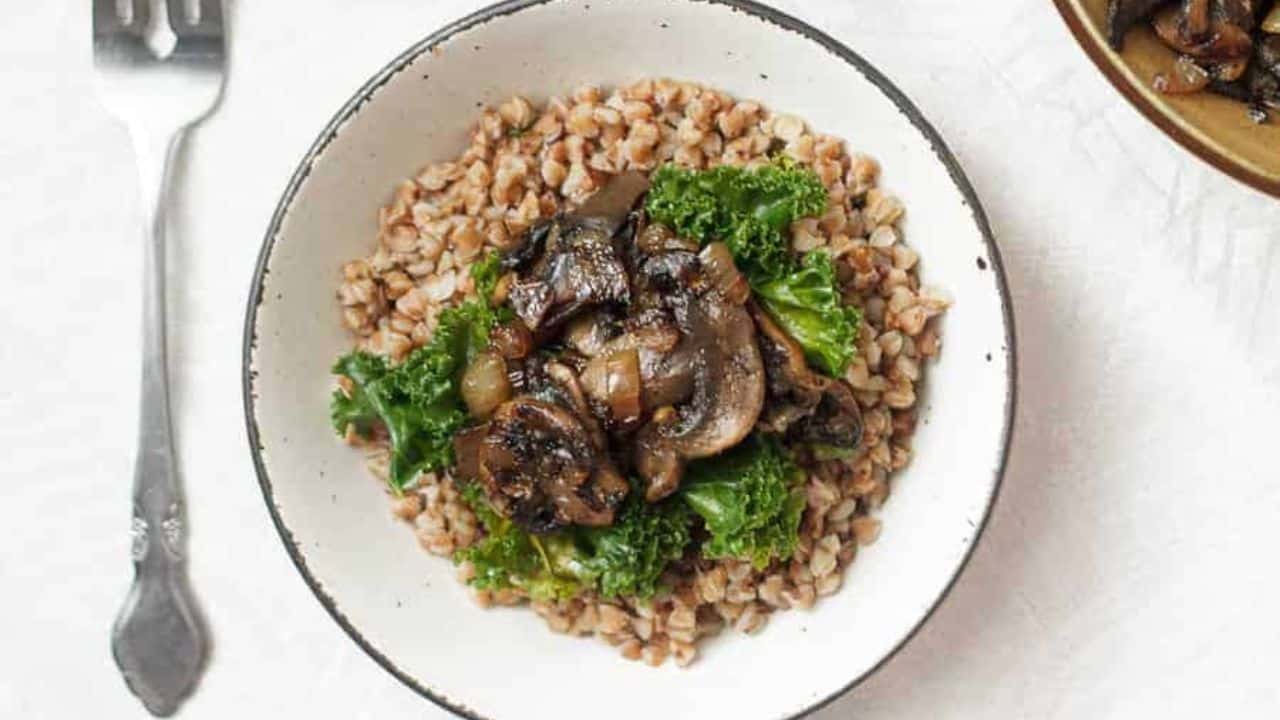 Three bowls of buckwheat kasha with mushrooms and greens.