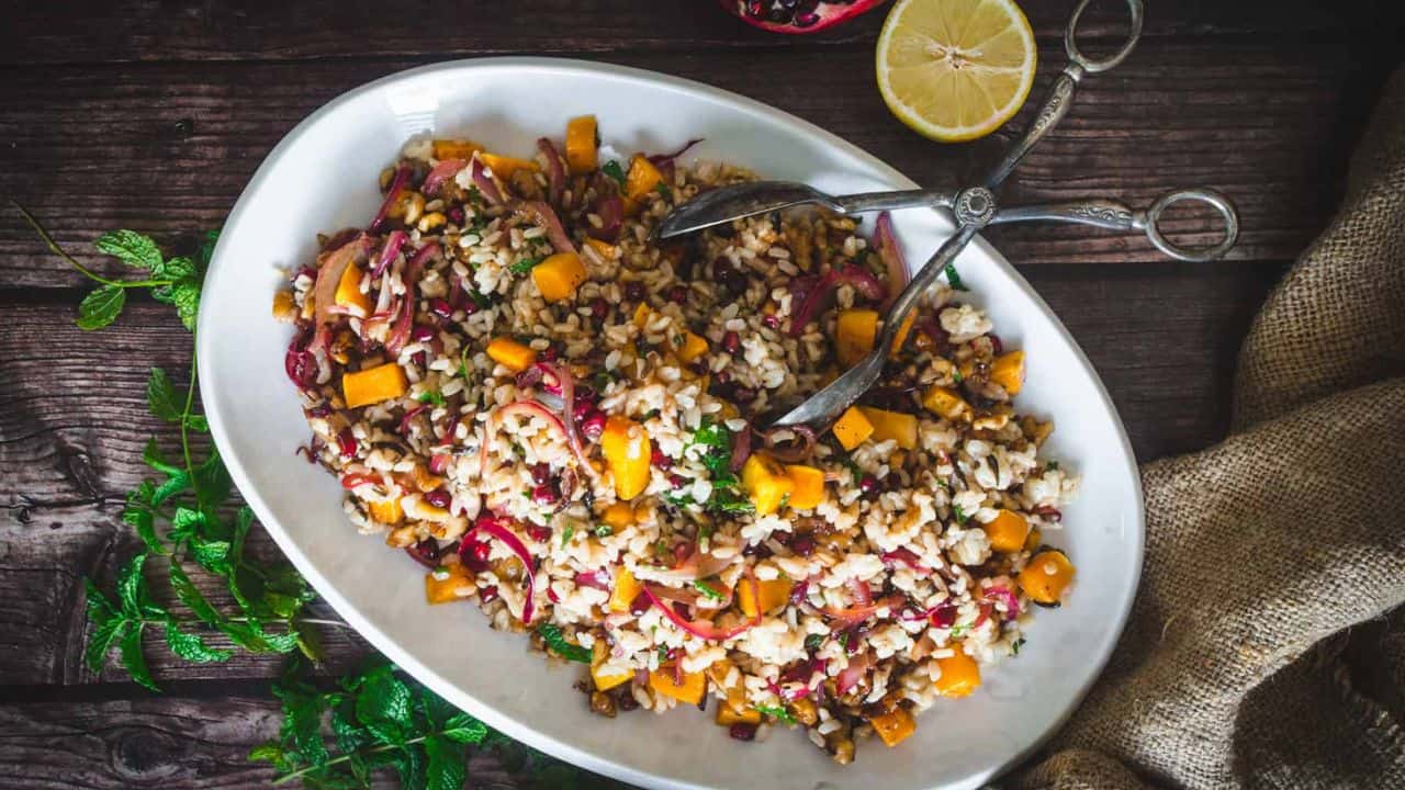 Side view of wild rice pilaf with pomegranate and butternut squash.
