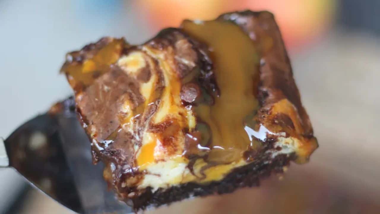 A piece of cake on a blue plate with a fork.