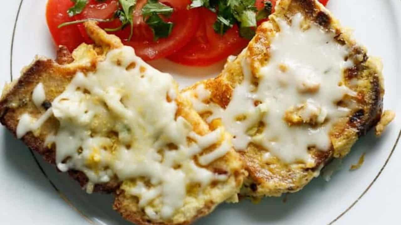 A slice of bread with cheese and sauce on it.