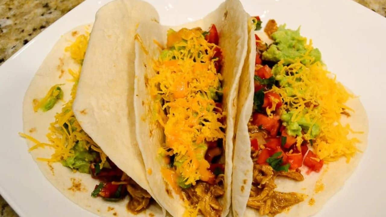 Three Chicken Tacos on a plate.