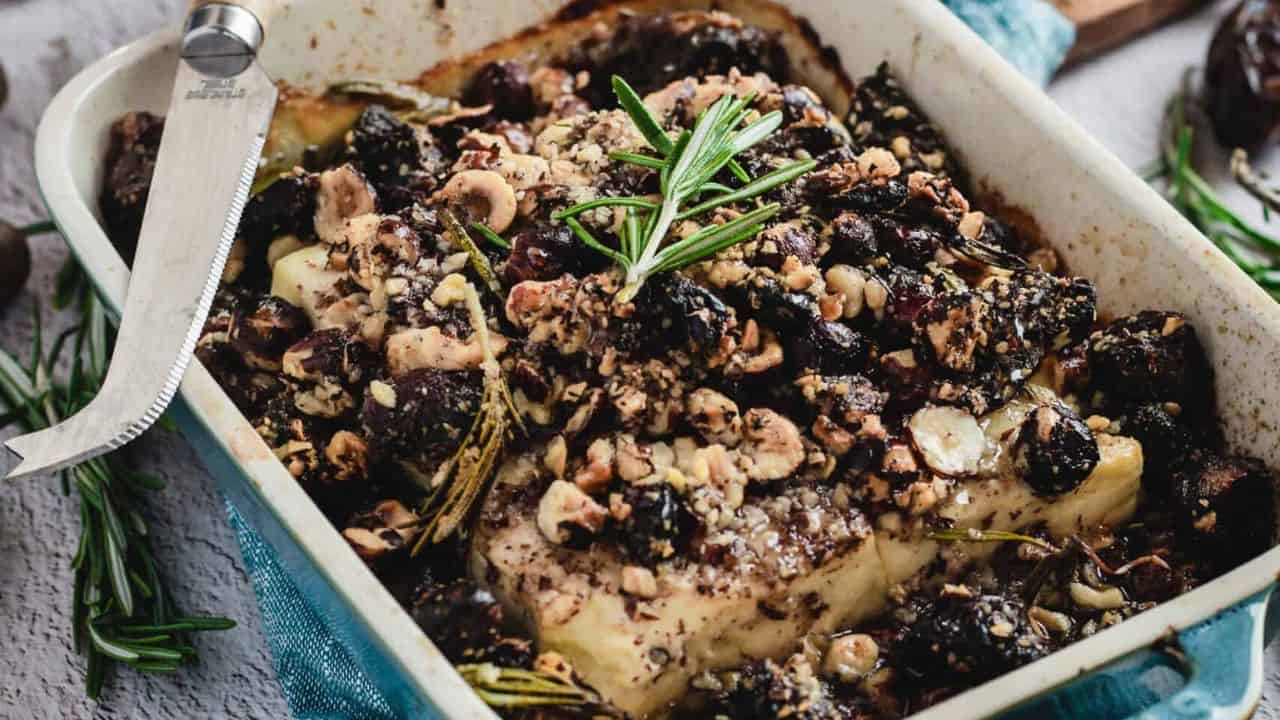 Baked feta in blue casserole dish.