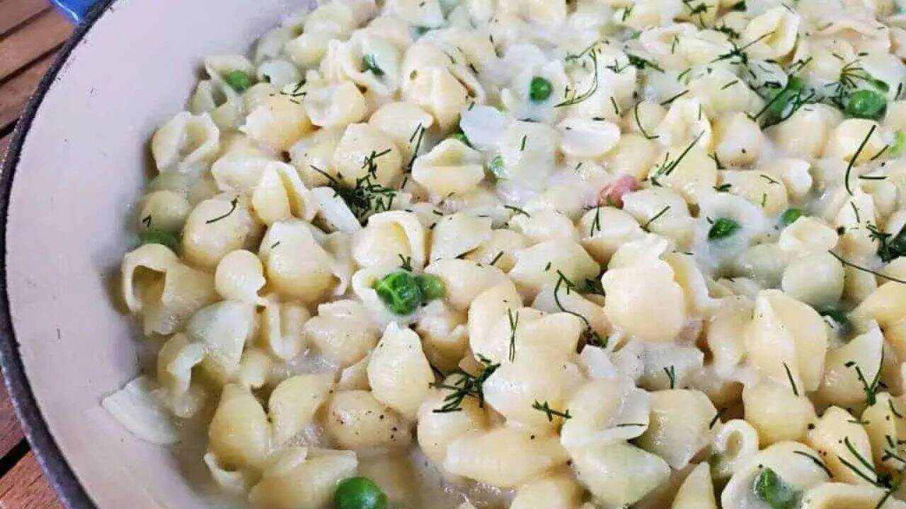 Image shows Creamy Pea Pasta in an enameled cast iron pot.