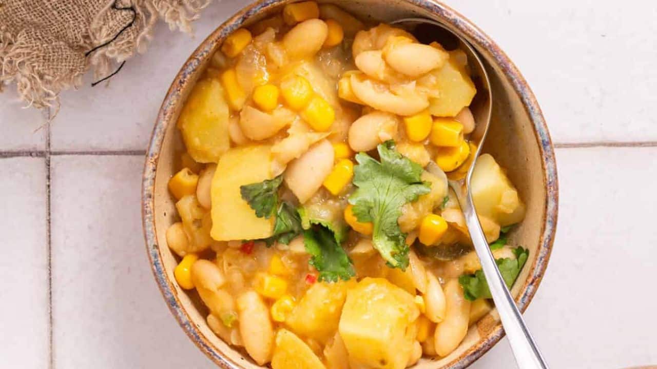 An overhead image of vegan white bean chili with toppings.