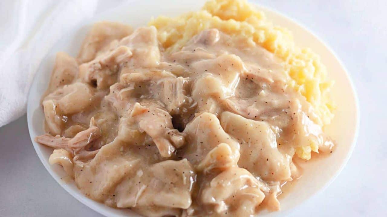A bowl of chicken and dumplings.