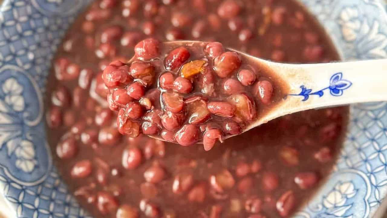 Close-up of warm red bean soup in a blue and white color bowl.