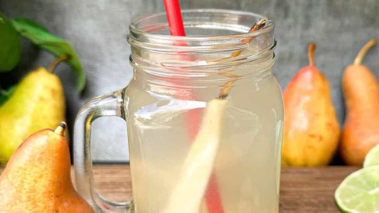 A warm and soothing ginger pear tea in a mason jar with a handle.