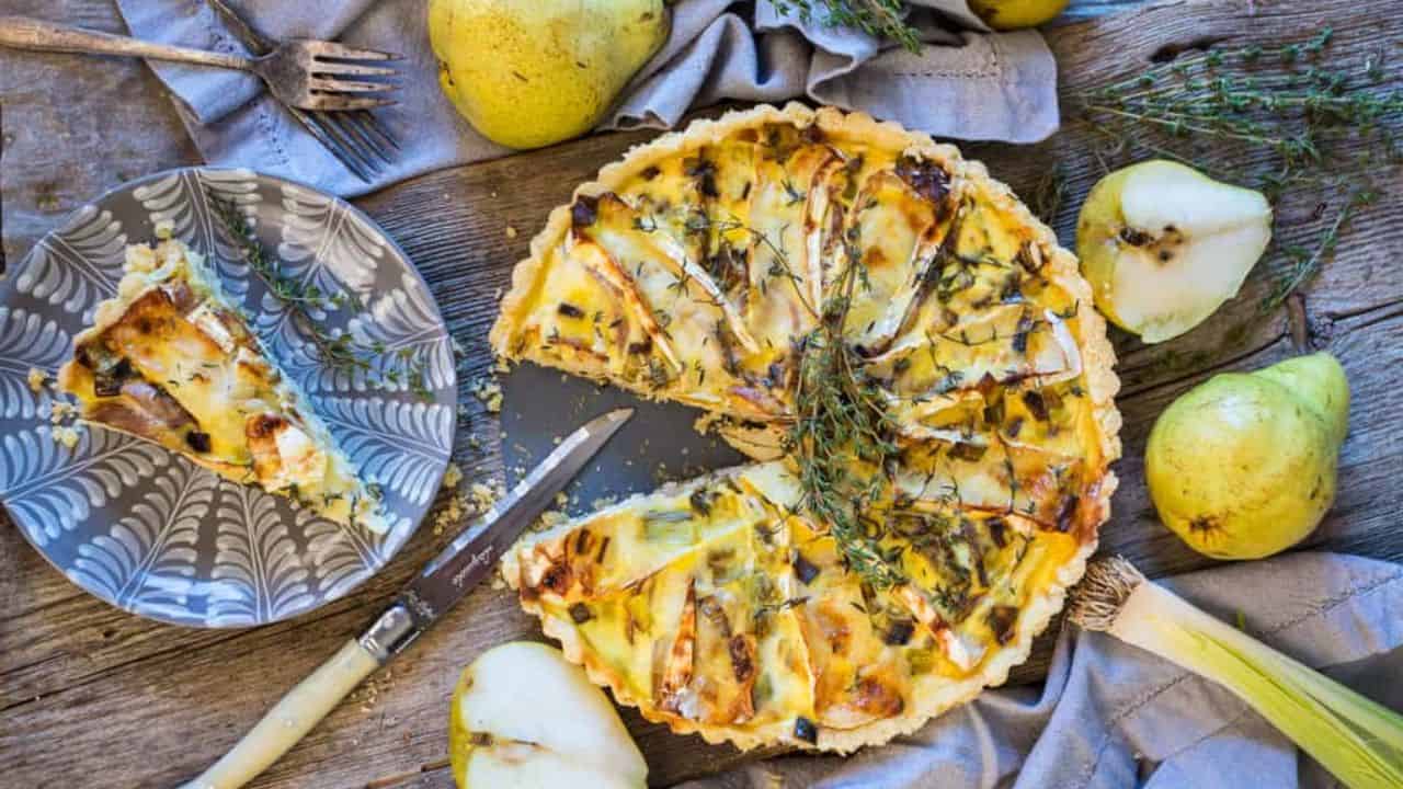 A quiche with pears and sprigs of thyme.