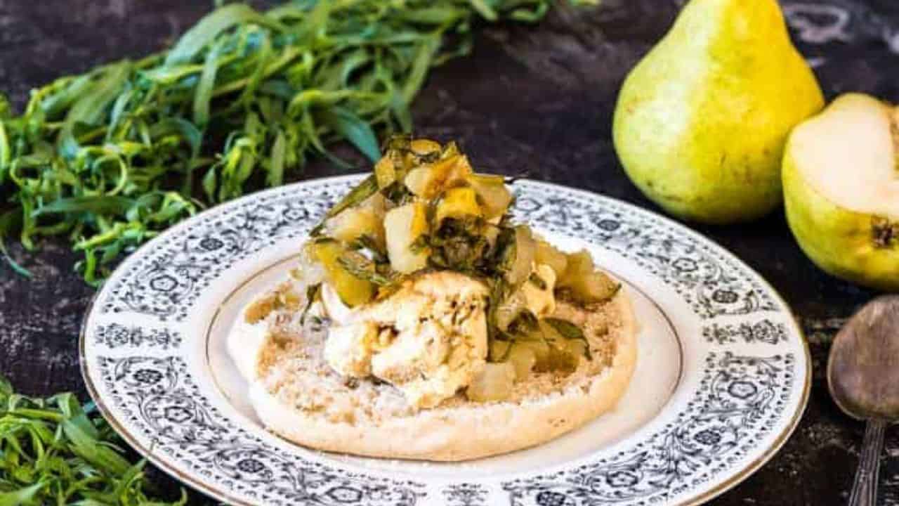 A plate with food and pears on it.