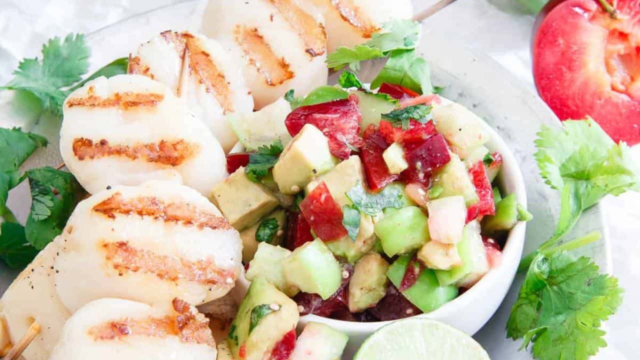 Grilled scallop skewers with plum tomatillo salsa.