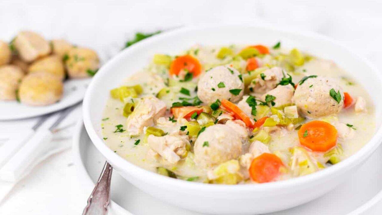 A bowl of homemade chicken soup with dumplings.
