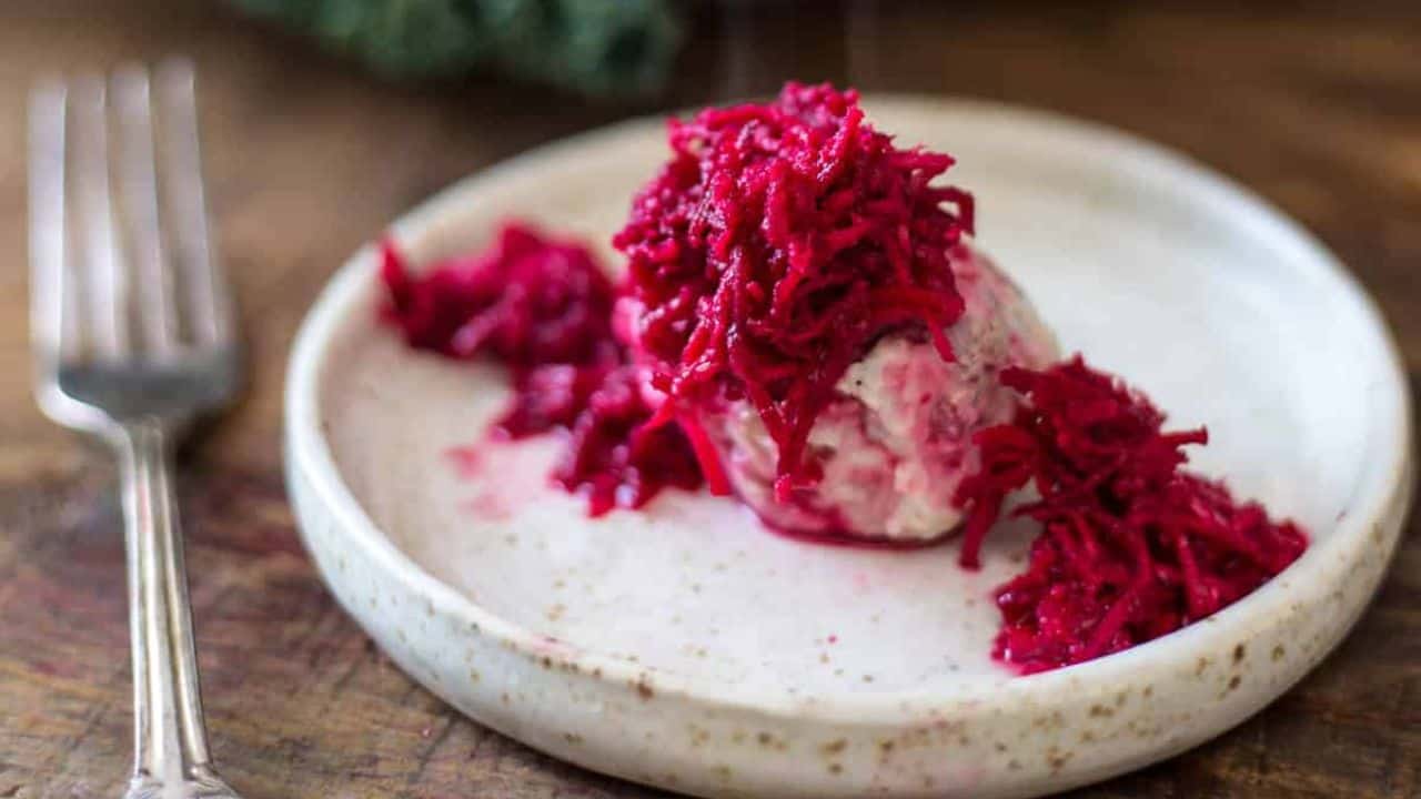 Gefilte fish on plate with beet horseradish.