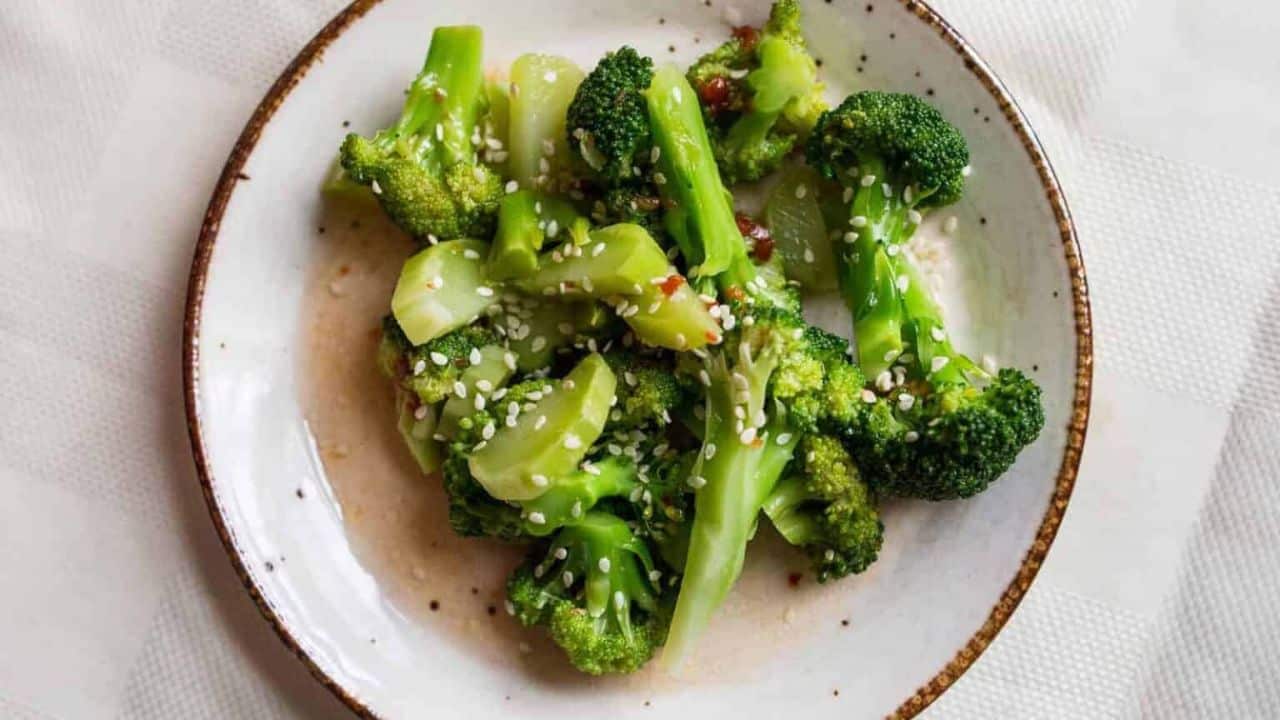 A bowl of broccoli in a white bowl.