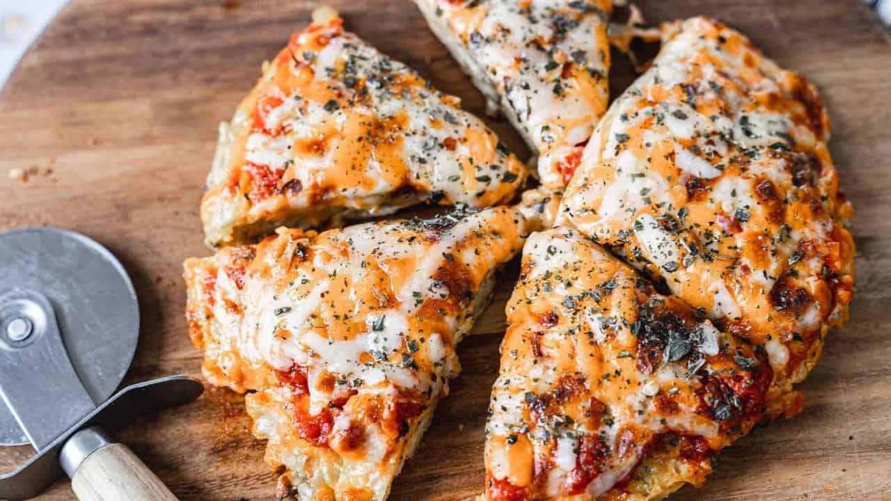 A slice of pizza on a wooden cutting board.