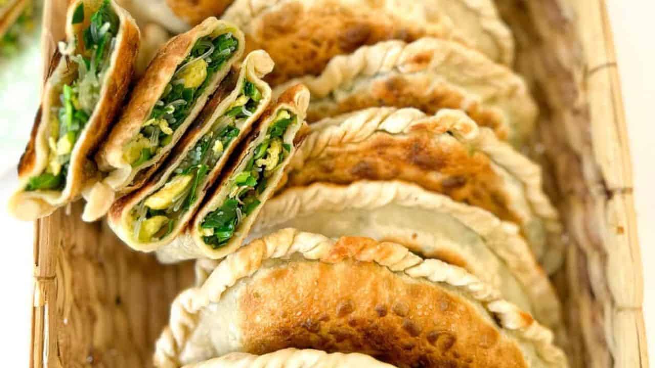 A basket filled with Chinese chive pockets with chives, glass noodles and egg filling.