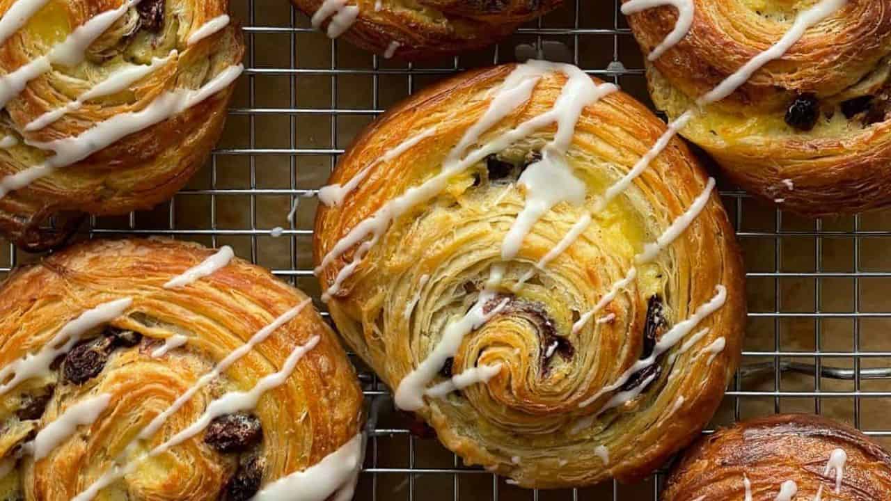 Pain aux raisins on a cooling tray.