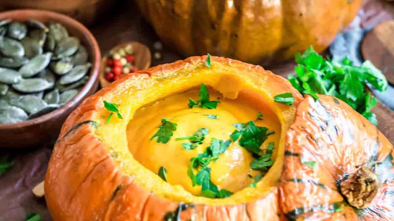 Creamy Roasted Pumpkin Soup inside baked pumpkin bowl.
