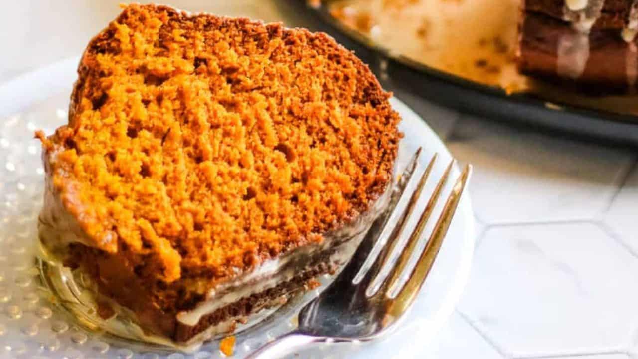 Pumpkin spice latte bundt cake with coffee glaze being poured over the top.