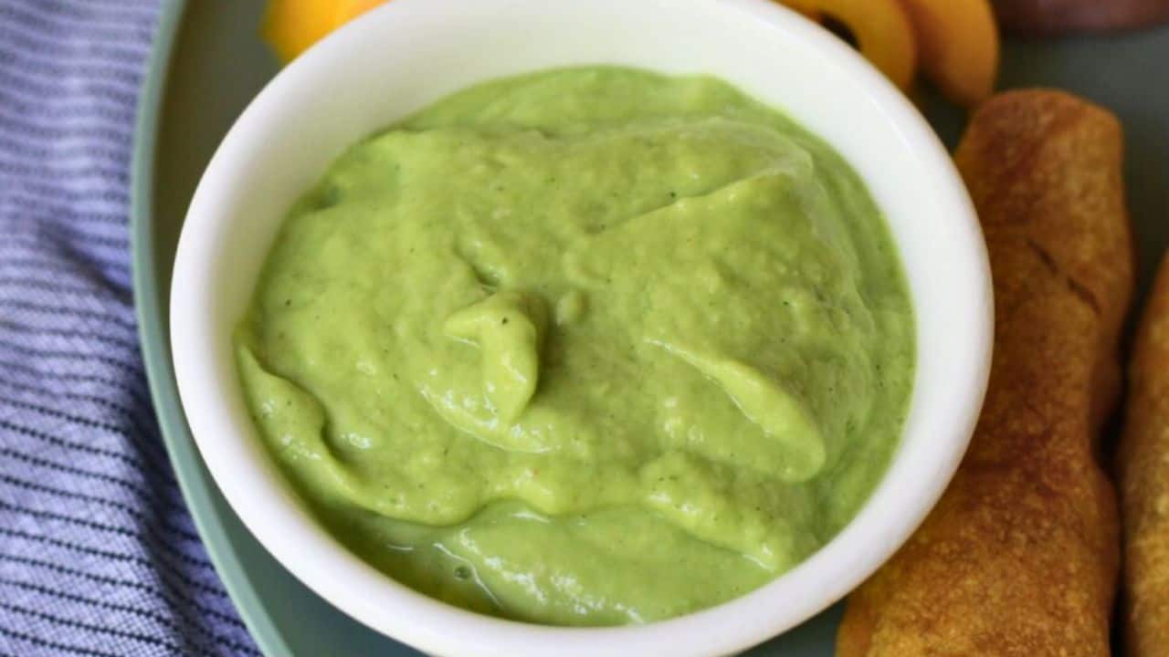 White bowl of salsa with flautas to the side.