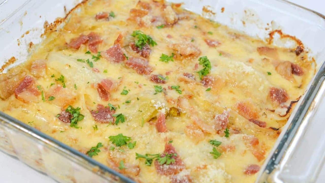 A casserole dish filled with cabbage, cheese and bacon.