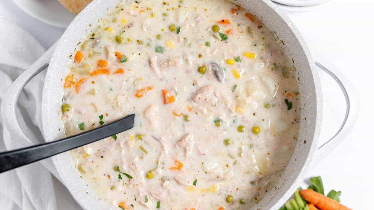 A bowl of chicken soup with veggies and chicken.