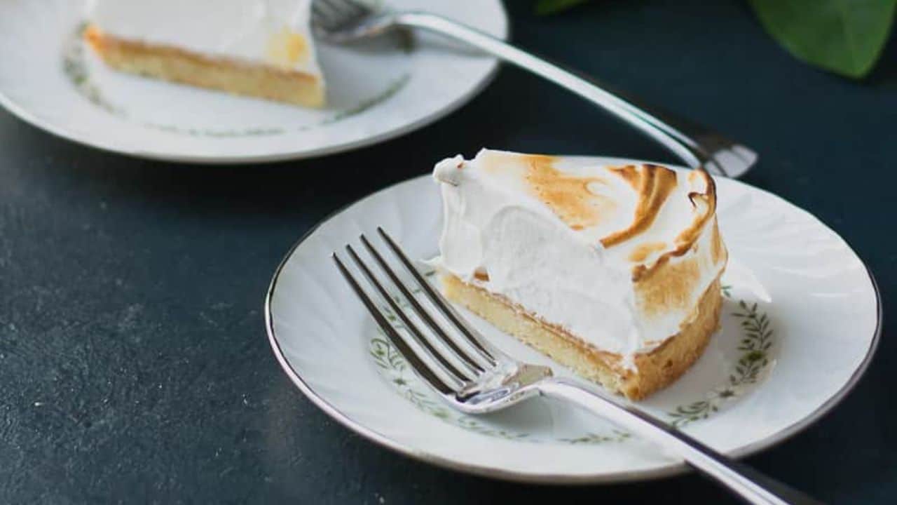 A plate with Citrus Dream Tart next to slices of grapefruit and blood orange.